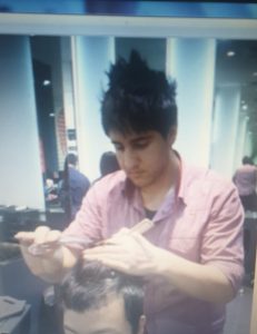 Ali cutting hair in 2012 - showing career growth.