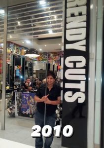 Ali smiling in front of hair salon in 2010